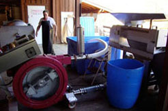 Owner of Conneaut Cellars Winery, Joal Wolf, is shown preparing grapes for wine production.