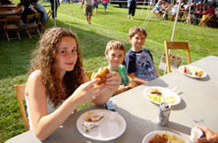 Kids and families are enjoying food at the Conneaut Cellars Winery June picnic event.